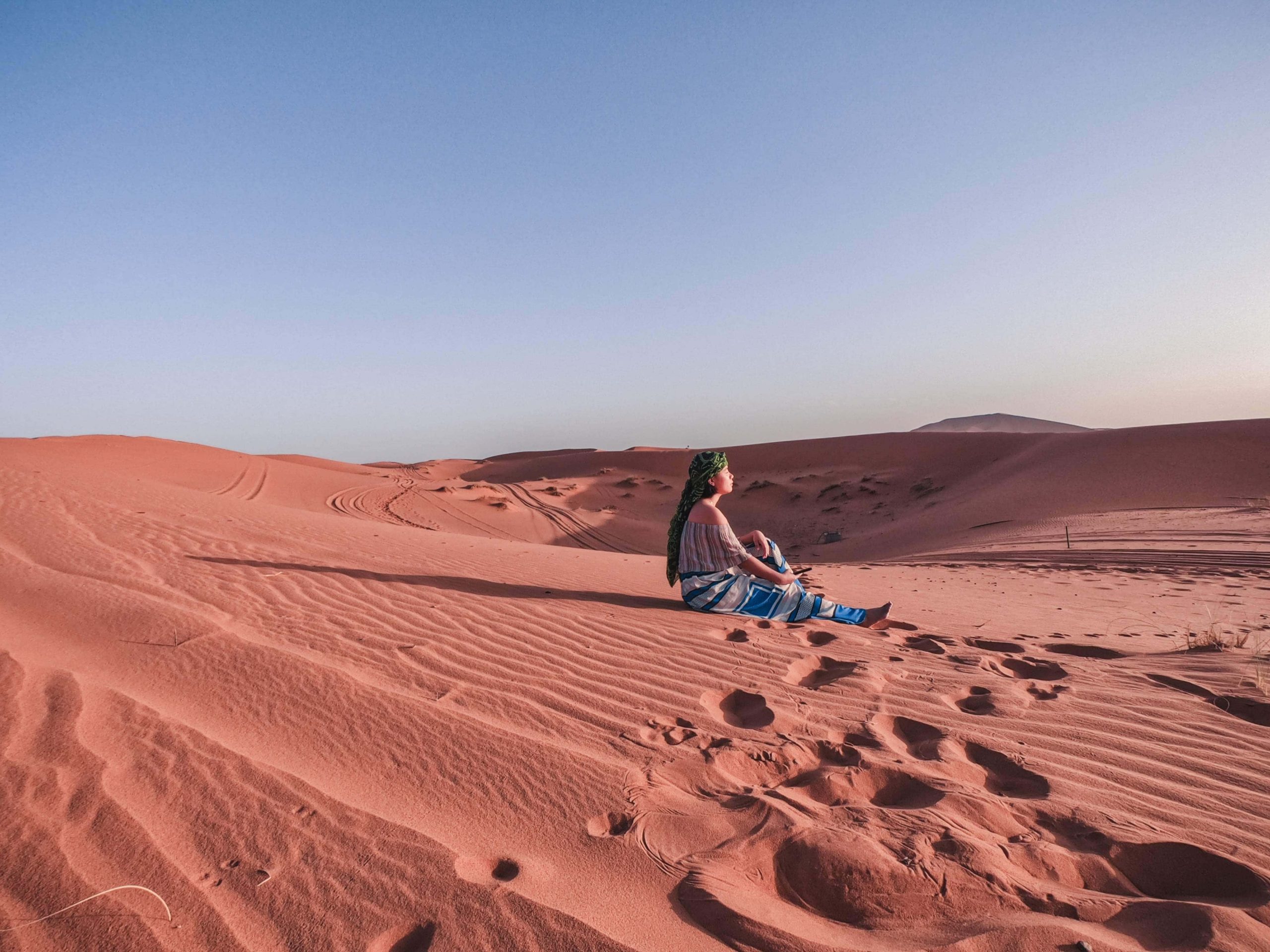 girl sitting on sahara desert