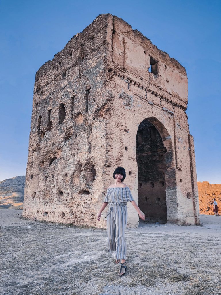 woman in front of an ancient ruin