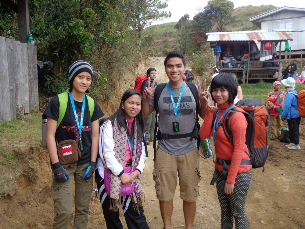 a group of young people preparing to climb the mountain