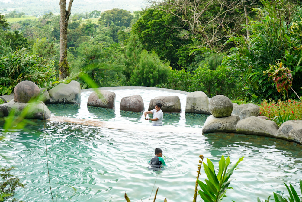 man and a boy in a swimming pool