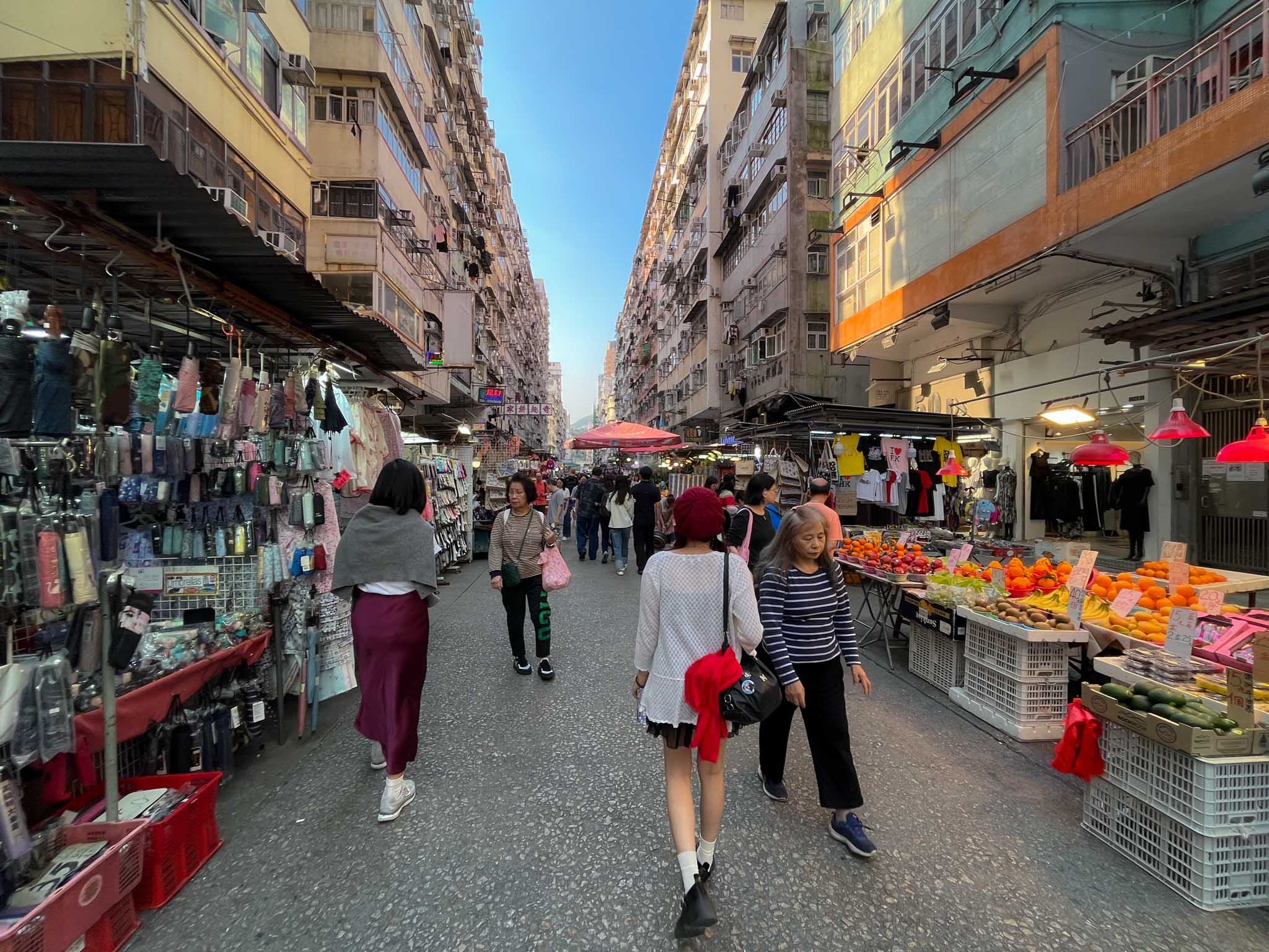 shoppers walking along the market