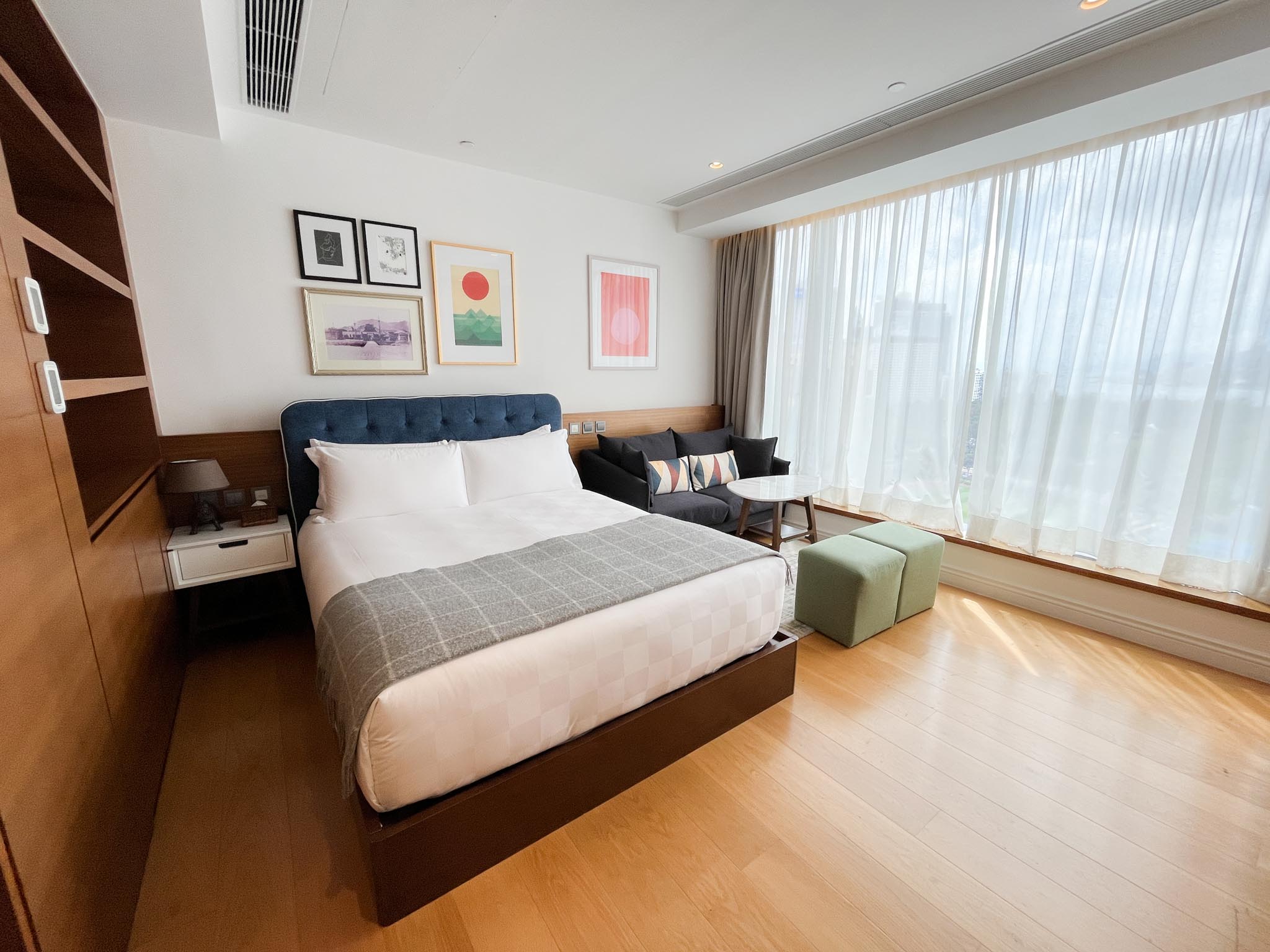 a queen bed and mini sofa